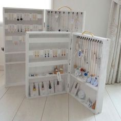 two white shelves filled with jewelry in a room