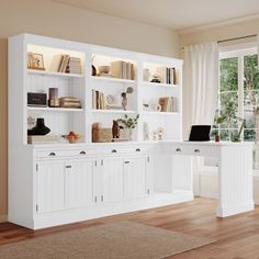 a white desk and bookshelf in a room