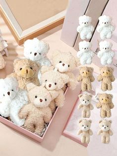 a box filled with lots of white teddy bears sitting on top of a pink table