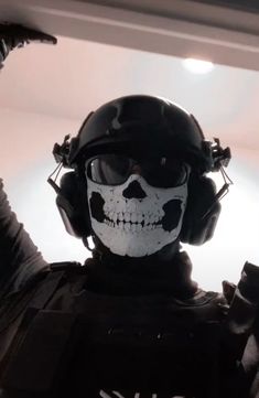 a man wearing a helmet and goggles with a skull painted on his face