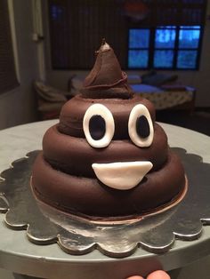 a close up of a chocolate cupcake with eyes