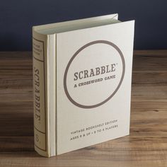 a book with the title scrabble a crossword game sitting on a wooden table