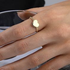 This gorgeous, delicate 14-carat gold band features a tiny gold heart. Its simple and elegant design makes it the perfect everyday piece or thoughtful gift for someone special.  RING DETAILS ♥ Gold Material: 14K Solid Gold ♥ Design: Minimalist rope band with a small heart ♥ Gold Color Options: 14K yellow gold, 14K white gold, or 14K rose gold ♥ Craftsmanship: 100% Handmade and made to order ♥ Versatility: Perfect for daily wear or special occasions ♥ 100 % Handmade ♥ Made to Order CUSTOMISATION DETAILS ♥ Choose your colour: 14K Yellow gold 14K White gold 14K Rose gold ♥ Select your ring size.  Use our ring size conversion table to convert your ring size according to your country of residence. PROCESSING & SHIPPING We know you're excited to get your hands on your order, and we're just as ex Dainty Stackable Yellow Gold Heart Ring, Dainty Yellow Gold Stackable Heart Ring, Dainty 14k White Gold Heart Ring, Gold Heart Ring For Mother's Day Promise, Gold Heart Promise Ring For Mother's Day, Gold Stackable Heart Ring Promise, Gold Stackable Heart Promise Ring, Gold Stackable Heart Cut Heart Ring, Gold Stackable Heart Cut Ring