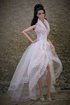 a barbie doll wearing a white dress and high heels