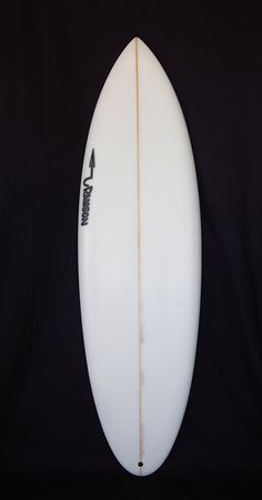 a white surfboard sitting on top of a black background