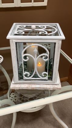 a glass table topped with a white candle holder