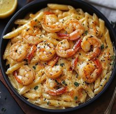 a skillet filled with pasta and shrimp