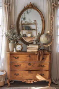 an old dresser with a mirror and clock on top