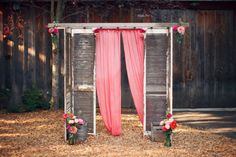 an outdoor ceremony with pink drapes and flowers