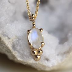 - Rose cut Oval Rainbow Moonstone measures 6 x 4mm  - Moonstone gives off hints of blue and purple in the light - Natural inclusions give a different texture to each stone, making each necklace one of a kind!   - Available on a 16" or 18" chain - Available in 14K white, rose, or yellow gold (pictured in yellow gold) - 1mm classic cable chain - Finished with a spring ring - Milgrain accented pendant Interested in a different gemstone?  Please contact me.  Processing times -  Current processing ti Oval Moonstone Natural Stones, Oval Natural Moonstone Gemstones, Oval Moonstone Gemstones With Spiritual Style, Oval Moonstone Gemstone Necklace, Oval Moonstone Cabochon Necklace, Moonstone Gemstone Oval Necklace, June Birthstone, Moonstone Necklace, Wedding Jewellery Necklace