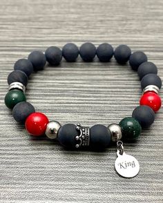 "This bracelet is made with round 10mm red dyed mountain jade stone beads, 10mm round black matte onyx stone beads, 10mm green dyed mountain jade stone beads with stainless steel rondel accents and a stainless steel crown  with a very small (smaller than a dime) stainless steel \"King\" charm.  Please select your WRIST SIZE. If you have any questions about sizing, please don't hesitate to ask. I'm here to help. :) Please keep in mind that the final design of the bracelet may be a little differen Black Jade Bracelets Gift, Bracelet Materials, Clay Bracelets, Bracelets For Boyfriend, Pan African, Fredericksburg Va, Clay Bracelet, Photo Charms, Bracelet Design