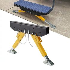 a yellow and black step stool sitting on top of a sidewalk next to a bus