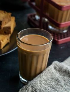 there is a cup of coffee next to some brownies