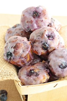 blueberry muffins in a basket on a table