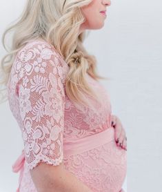 This knee-length floral lace dress is simply a dream! With a satin belt to accentuate your bump, the gorgeous Scarlett dress is perfect for any special event, including a Baby Shower. Features high quality stretch fabric, transparent lace along the upper neckline and arms, and 3/4 length sleeves. Color: Pink Knee-Length Stretch Fabric: 90% Nylon 10% Spandex Maternity, Non-Maternity & Nursing-Friendly Size Chart Questions? Use the chat icon (lower right) to connect with one of our stylists! Spring Wedding Lace Dress With Lace Closure, Pink Lace Top Dress, Pink Lace Dress With Lace Top, Spring Lace Maternity Dress With Short Sleeves, Pink Fitted Lace Dress With Lace Sleeves, Fitted Pink Lace Dress With Lace Sleeves, Pink Fitted Maternity Dress For Party, Spring Wedding Dress With Lace Closure, Fitted Summer Maternity Dress With Lace Trim