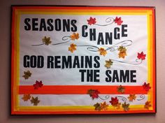 a sign that says seasons change god remains the same with autumn leaves and orange ribbon