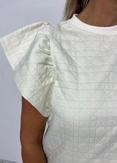 Alexander Quilted Top Chic Crew Neck Short Sleeve Top For Day Out, Chic Short Sleeve Crew Neck Top For Day Out, White Ruffled Tops For Loungewear, Beige Ruffle Sleeve Tops, Trendy Cream Tops With Ruffles, Chic Cream Tops With Ruffle Sleeve, Chic Beige Top With Flutter Sleeves, Chic Beige Tops With Flutter Sleeves, Chic Beige Flutter Sleeve Top