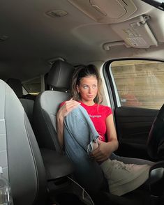 a woman sitting in the back seat of a car