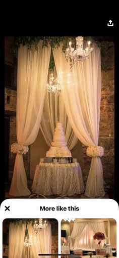 a wedding cake sitting on top of a table under a chandelier