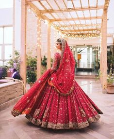 a woman in a red bridal gown