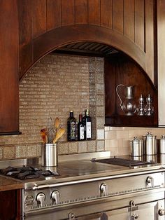 a stove top oven sitting inside of a kitchen next to a wooden cabinet and counter