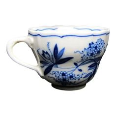 a blue and white cup with flowers on it