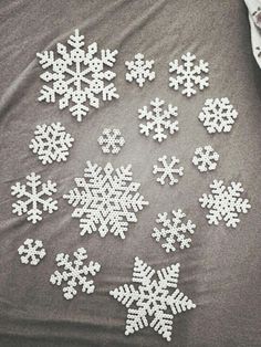 the snowflakes are all white and have been made out of plastic beads on them