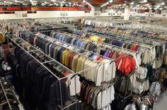 a rack filled with lots of shirts in a store