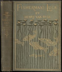 an old book with gold lettering on the front cover and two fish swimming in the water