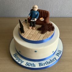 a birthday cake with an old man sitting on a couch