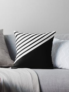 black and white striped pillows on a gray couch with grey throw pillow cover in the corner