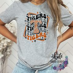 Treat yourself or anyone in your life to this awesome School pride tshirt. It's a Tiger thing.  Great for all occasions.  And great for supporting your Tigers team.  Shirt is made of 95% polyester and 5% spandex. It is soft with great stretch. It is a unisex style shirt.   To get the best wear from your shirt please  1. Wash with mild detergent  2. Do not use fabric softener  3. Do not use bleach 4. Tumble dry low.  Please enjoy your shirt as I know we have enjoyed all the ones we have made for ourselves!! Please note that every shirt is made to order and normal processing time takes us 3-5 business days to create a shirt and ship out an order; however, we strive our very best to get it out sooner!  *some shirts are made by a process called sublimation printing. It is normal if you see som Tiger Pride Shirts, Collegiate T-shirt With Custom Print For Game Day, School Spirit T-shirt For Cheerleading In Fall, Tiger Mascot Shirt Ideas, Varsity T-shirt With Custom Print For Game Day, Team-colored T-shirt For Game Day In Fall, College Team Spirit T-shirt For Fall, Team Spirit Game Day T-shirt For Fall, Team Spirit T-shirt For Game Day In Fall