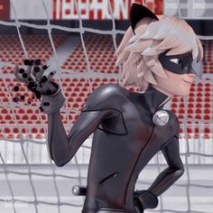 a woman in black cat suit standing next to a soccer goal with her hand up