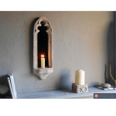 a candle is lit on a mantle in a room