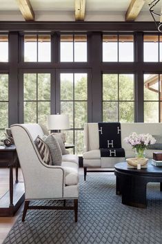 a living room filled with furniture and windows