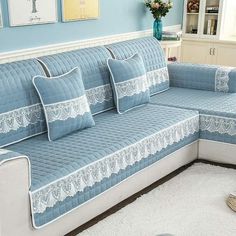 a blue couch with white lace on it