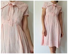 Cute fifties or early sixties dress. This dress is made out of a soft and shiny jaquard woven pink fabric. There is a large collar with bow, a fitted bodice and a pleated skirt. There is a zipper on the back and the collar opens with snap buttons to allow the zip to open all the way. Cute dress is good condition, would fit best for a size S, check out the measurements for additional sizing information Model is a size xs/s and 1,70m tall,all measurements taken flat, double for circumference. Armp Pink Daywear Dresses With Bow, Pink Fitted Dress With Peter Pan Collar, Pink Retro Dress With Peter Pan Collar, Summer Formal Dress With Peter Pan Collar, Feminine Pink Dress With Peter Pan Collar, Retro Pink Collared Dress, Vintage Pink Collared Dress, Pink Vintage Collared Dress, Sixties Dress