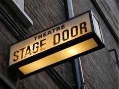 the theatre stage door sign is lit up