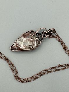 Beautiful Crazy Lace stone wire wrapped in oxidized copper wire to give it an antique look. Features square wire twisted into swirls to make a lovely design at the top. Pendant is 2.25 inches tall and 1 inch wide. Comes with a free chain! Copper Teardrop Wire Wrapped Jewelry, Wire Wrapped Teardrop Copper Jewelry, Silver Teardrop Jewelry With Copper Wire, Silver Teardrop Jewelry In Copper Wire, Hand Forged Silver Jewelry In Copper Wire, Hand Forged Silver Copper Wire Jewelry, Hand Forged Silver Jewelry From Copper Wire, Unique Copper Wire Teardrop Pendant Jewelry, Bronze Wire Wrapped Spiral Jewelry