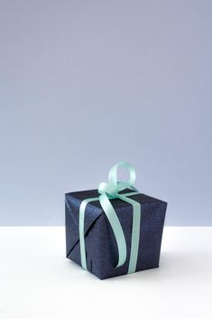 a blue gift box with a green ribbon