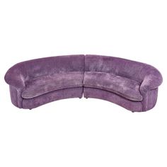 a curved purple couch on a white background