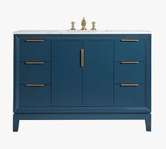 a bathroom vanity with two gold faucets on the top and blue cabinet doors