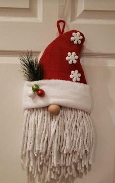 a red and white christmas decoration hanging on a door