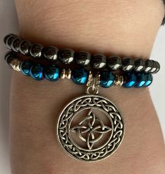 Celtic knot pendant bracelet, with blue and black hematite beads. Blue Hematite Jewelry As A Gift, Blue Hematite Jewelry For Gift, Outlander Jewelry, Celtic Knot Bracelet, Celtic Knot Pendant, Scottish Jewellery, Scottish Wedding, Knot Bracelet, Hematite Beads