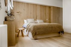 a bed sitting in the middle of a bedroom next to a radiator and wall