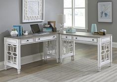 a white desk with two drawers and a laptop on it in front of a window