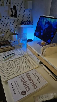 a desk with some books and a computer on it