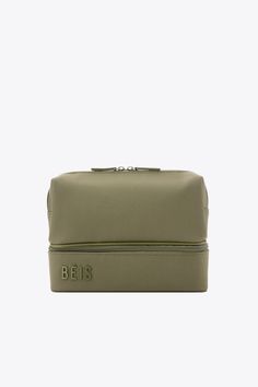 an olive green cosmetic bag with the word paris on it