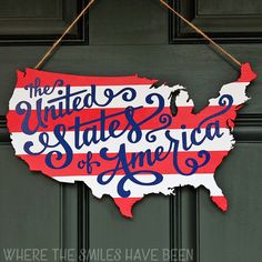 a sign that says the united states of america hanging on a door with an american flag painted on it