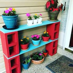 an outdoor shelf with potted plants on it